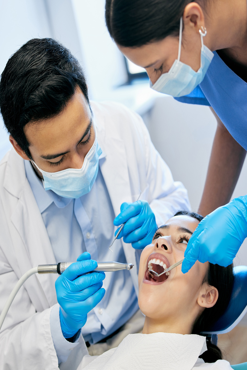 Dentist team, patient and mouth inspection for hygiene with healthcare and consultation and surgery for tooth extraction. People, teeth cleaning and orthodontist with medical procedure for veneers.