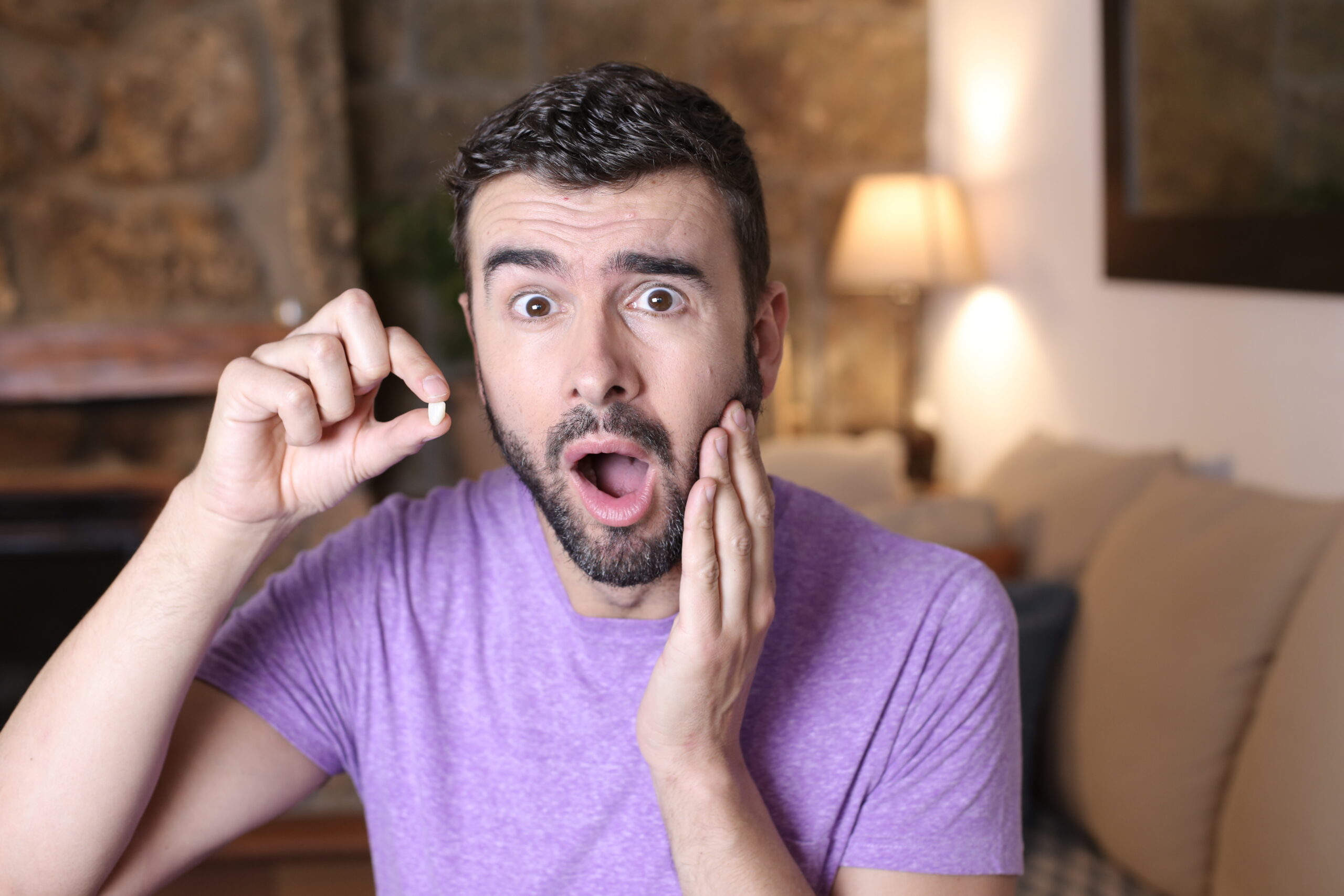 Young man losing a tooth